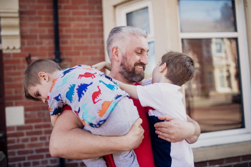 Improving tenants lives - father holding his children