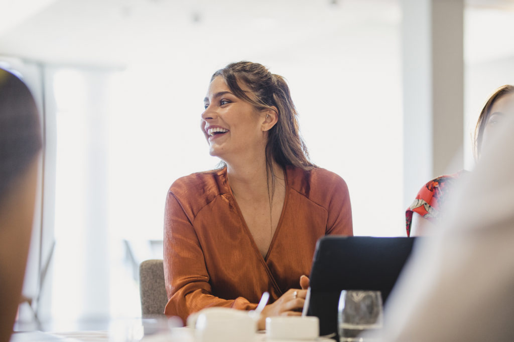 Woman smiling in meeting in office