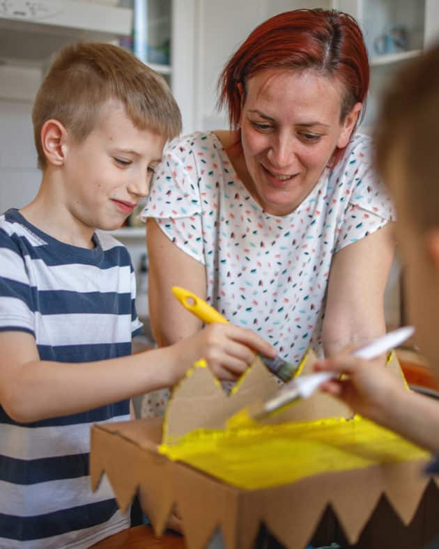 Mum and children painting in the kitchen