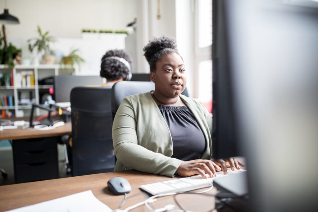 Manager looking at reports at desk in office