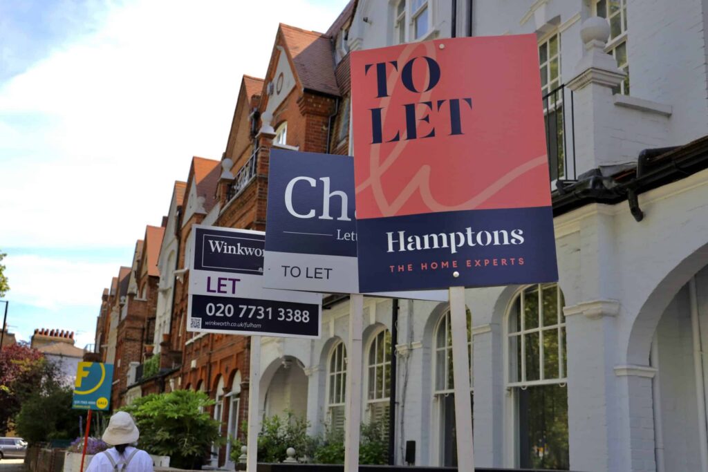 A row of brick terraced houses with multiple "To Let" signs displayed in front hints at shifts from the Renters Reform Bill. A person wearing a hat strolls along the sidewalk, perhaps contemplating new opportunities. ©Mobysoft